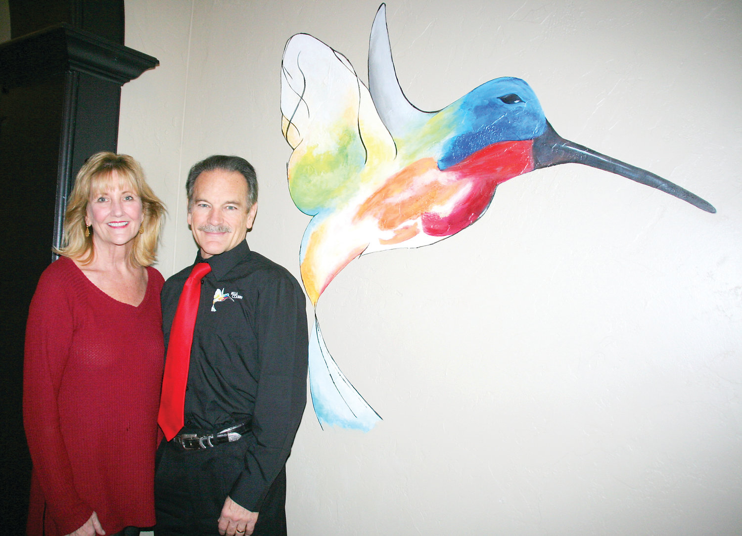 Aimee and Dean Valdez stand in the entryway of their new restaurant, Bella Colibri. The name in Italian means beautiful hummingbird. The hummingbird in the entryway was painted by Golden artist Alyssa Graves..